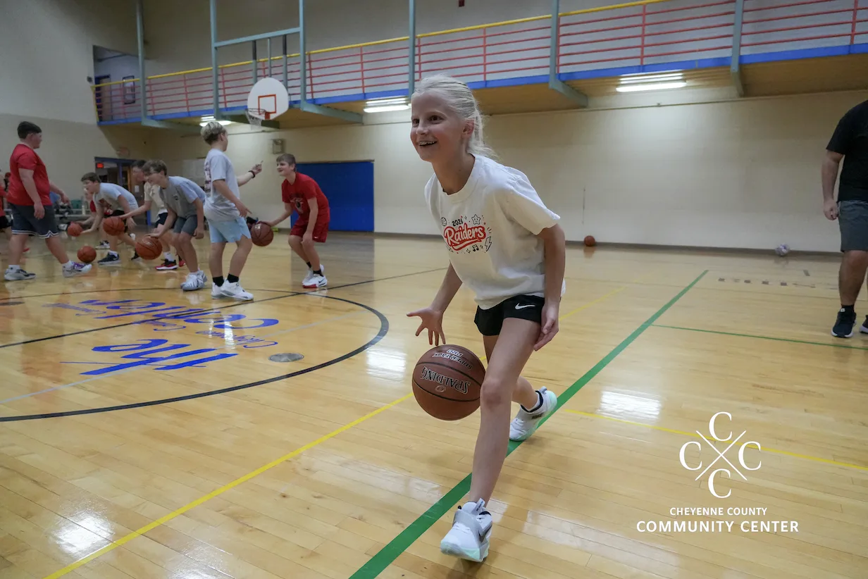 Youth basketball player dribbling down the court during a practice at The Center